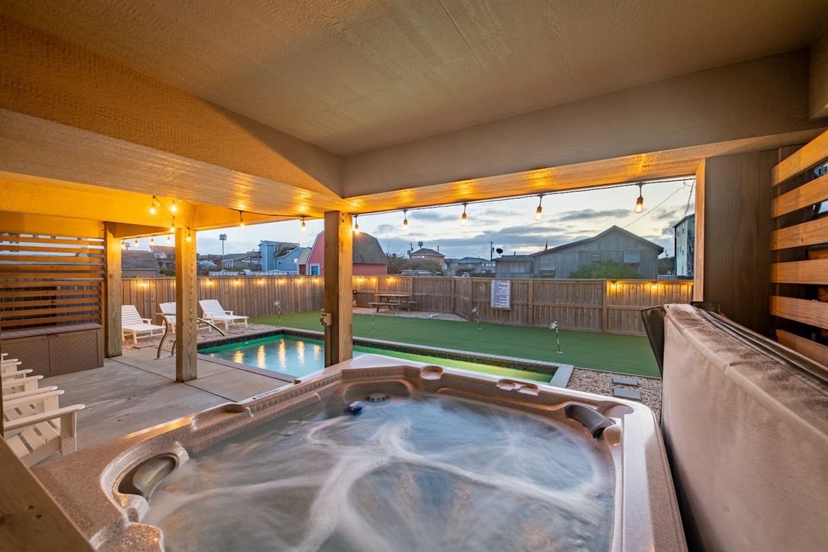 Relax in our inviting backyard which includes a pool, hot tub, putting green and beautiful polywood chairs...