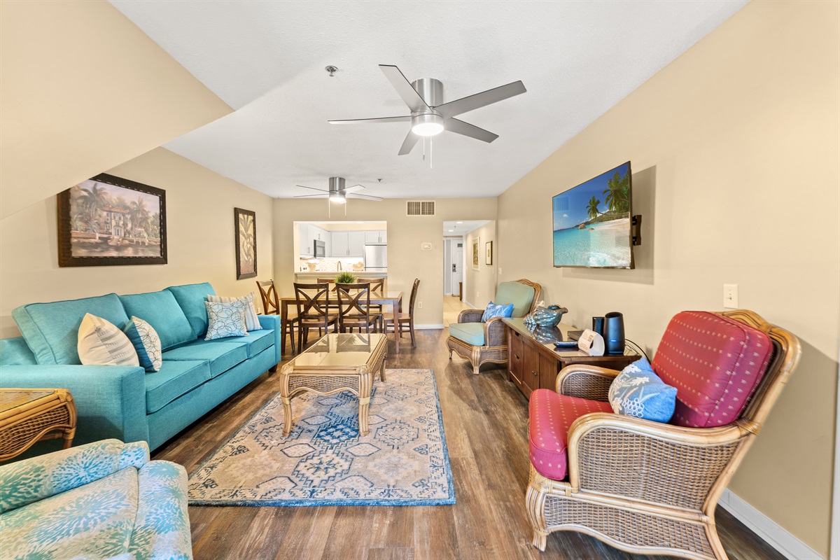 Open concept- large living area with sleeper sofa, large TV and patio access