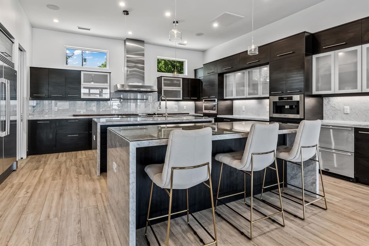 Kitchen with double islands massive stove and huge refrigerator.