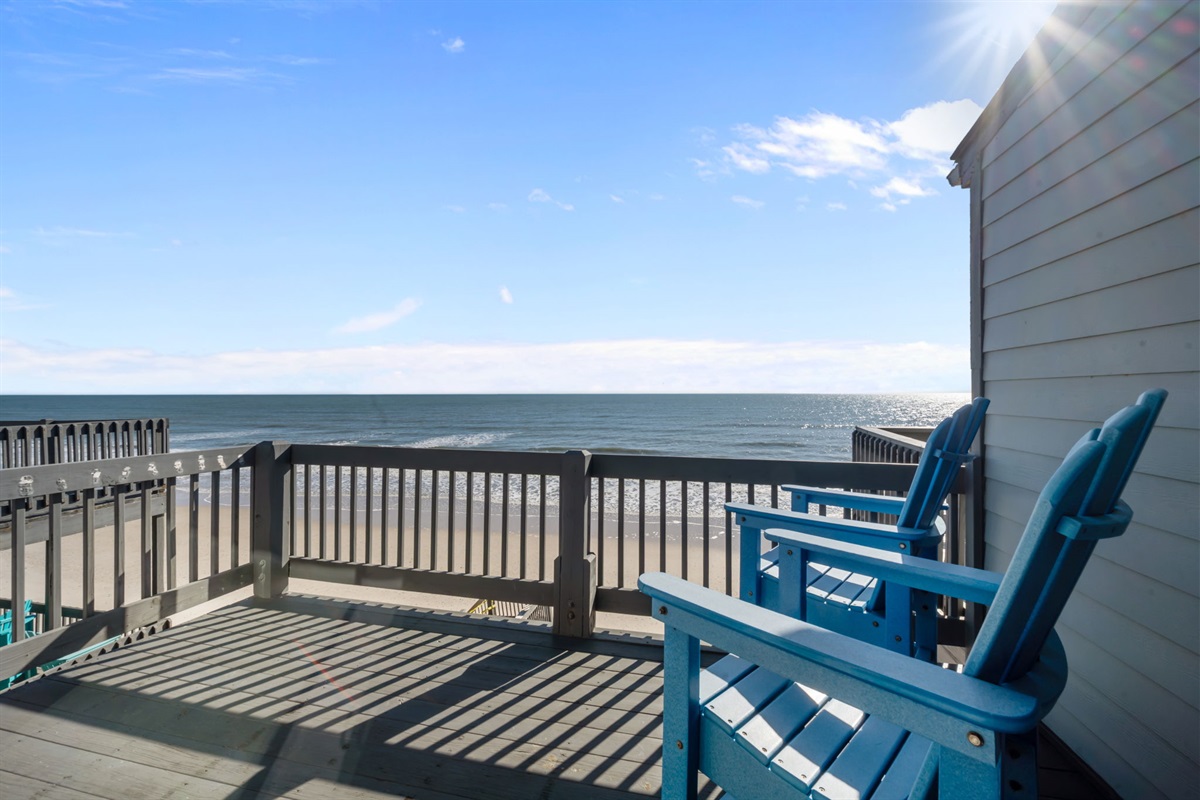 Oceanfront deck with Adirondack seating and unobstructed views&mdash;an ideal place to relax, watch the waves, and soak in the coastal atmosphere
