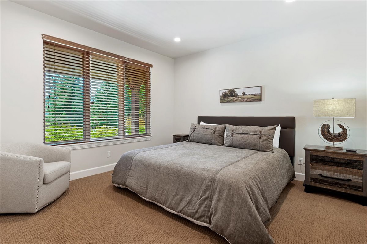 Another view of the king suite, offering plenty of space to relax along with a cozy seating area and natural light throughout