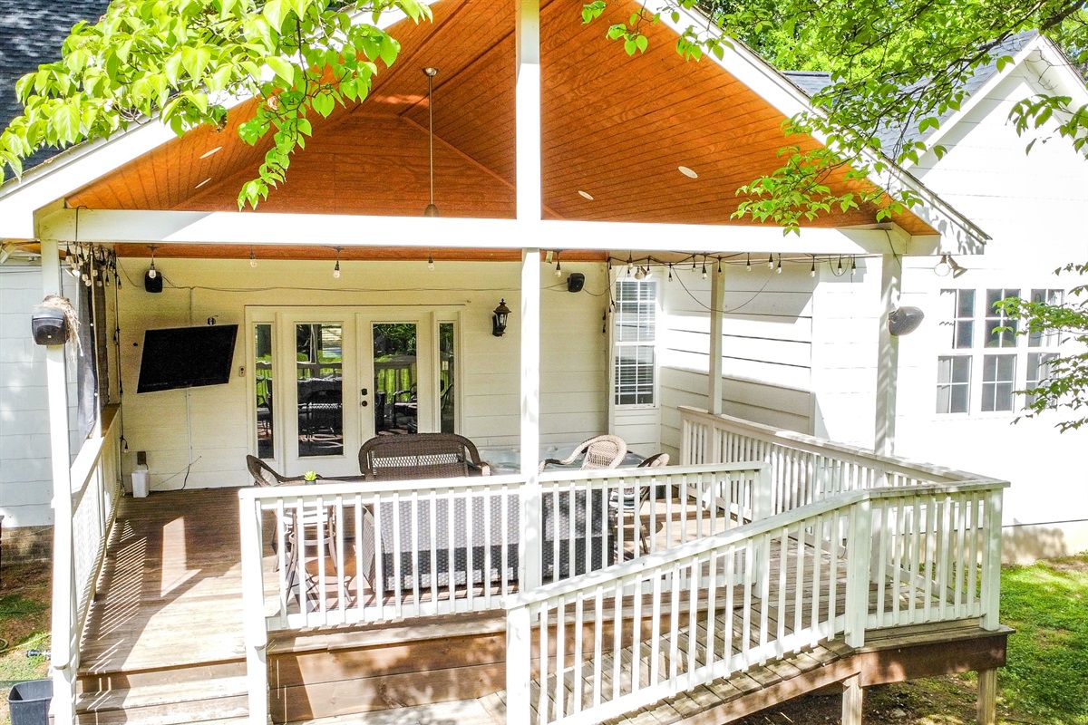 Covered deck with hot tub and TV