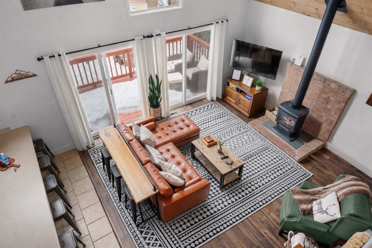 Looking down at the heart of the chalet, where wood ceilings, rich colors, and cozy vibes create the perfect chalet. 