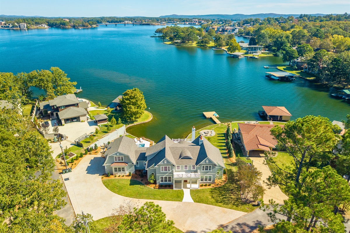 Lakeside property surrounded by trees and open water.