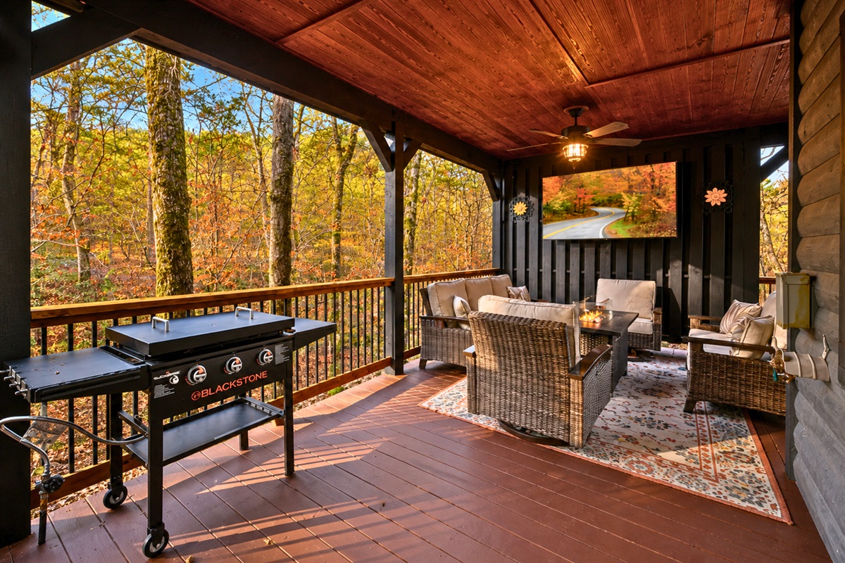 Out on the covered deck, comfortable seating creates the perfect setting for morning coffee or relaxing evenings surrounded by nature.