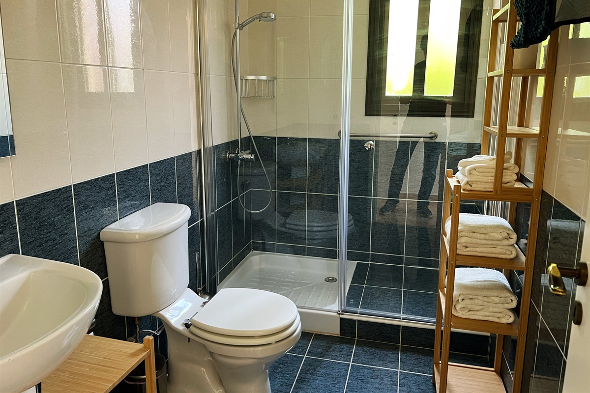 Full bathroom with walk-in rain shower and heated towel rails. Ensuite to the master bedroom.