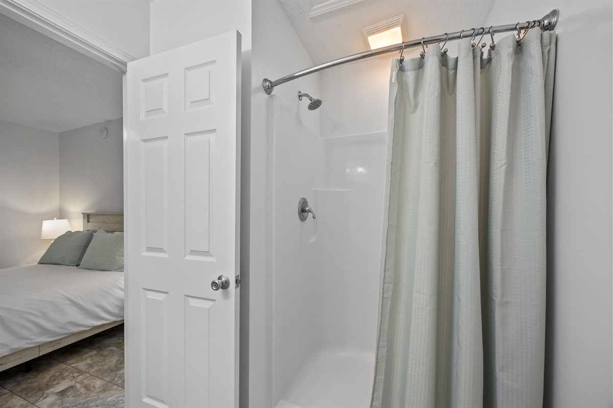 Ground-level bathroom with shower/tub combo located directly next to the bedroom for easy access