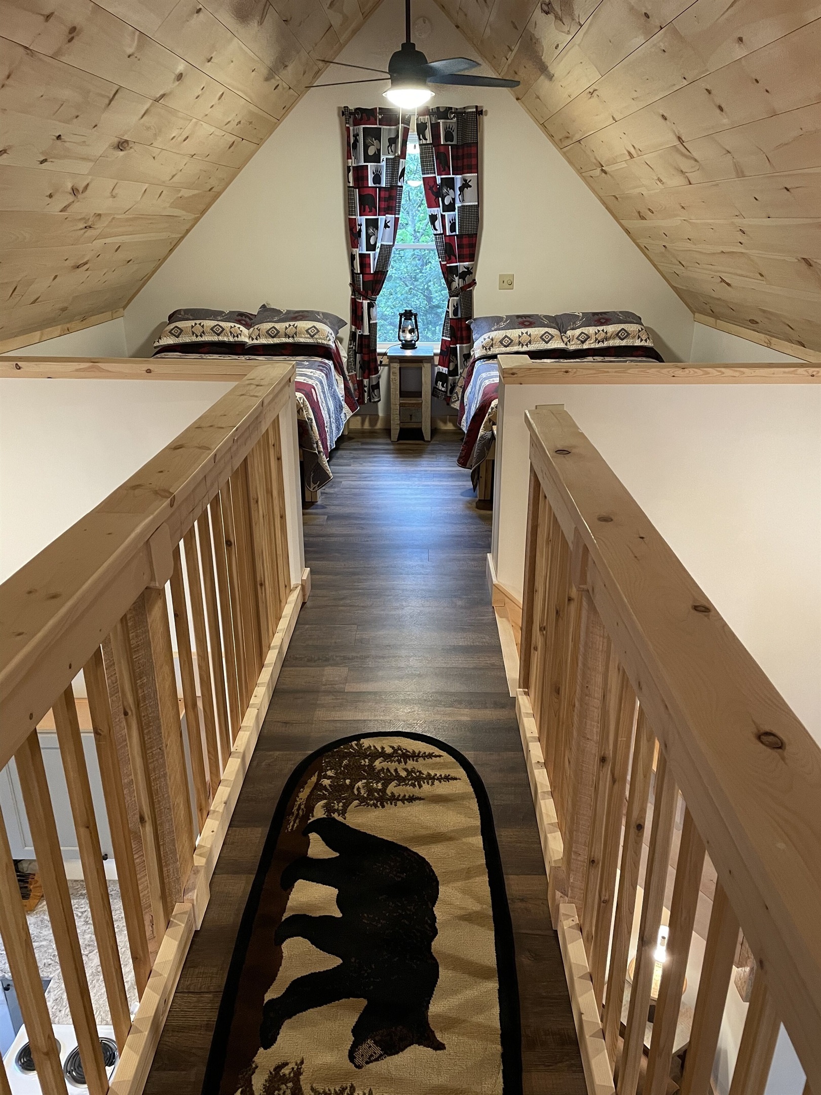 Cat walk connecting 2 sides of the loft, each side with 2 full beds.