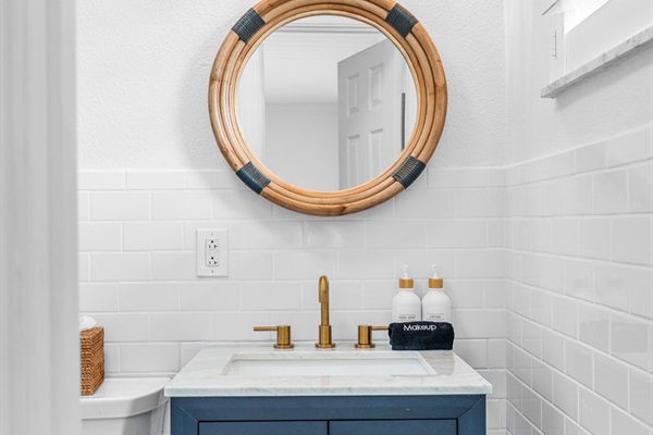 Stylish powder room with coastal accents and warm lighting