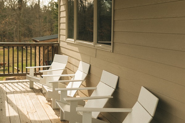 Deck with Adirondack chairs with a great view of our wooded acreage
