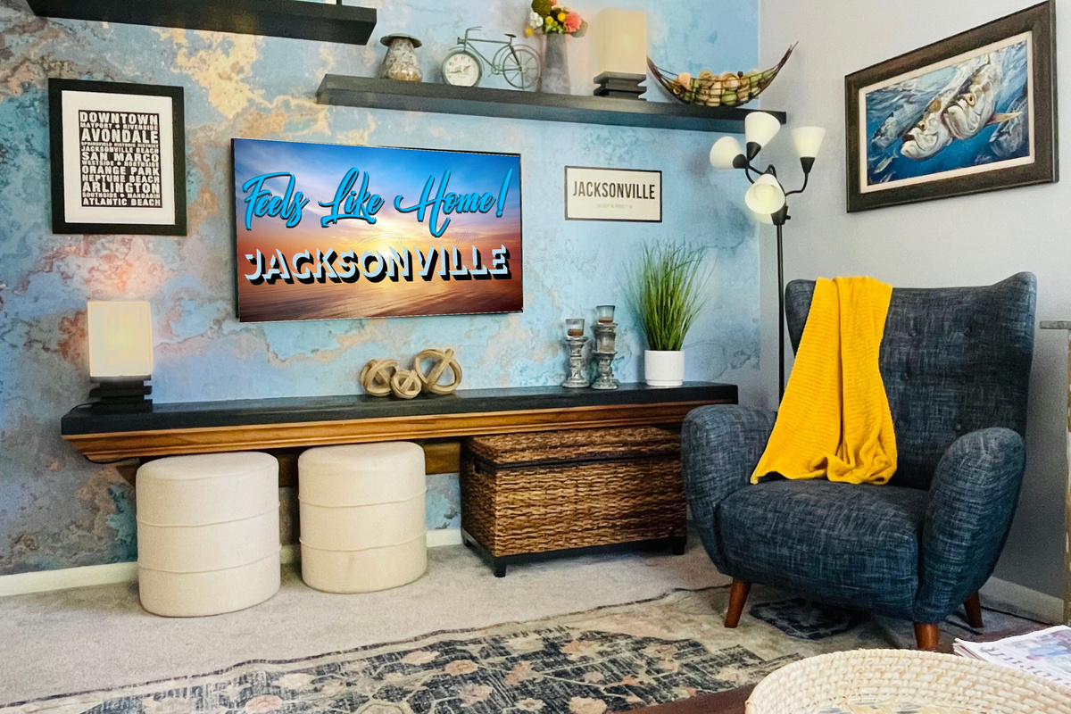 Living Rm: 65” TV, lamps, 2 stools, large chair & wicker box of board games
