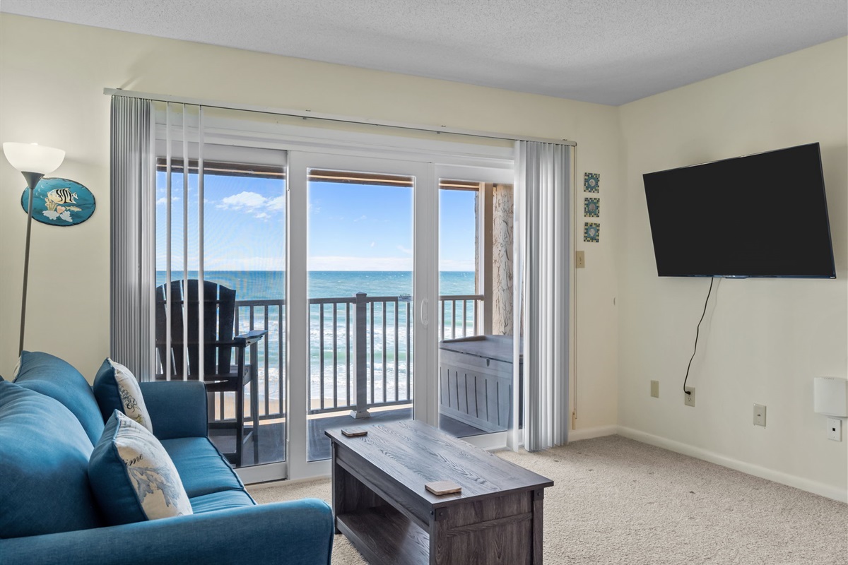 Floor-to-ceiling doors frame uninterrupted ocean views, filling the living space with light and sea breezes
