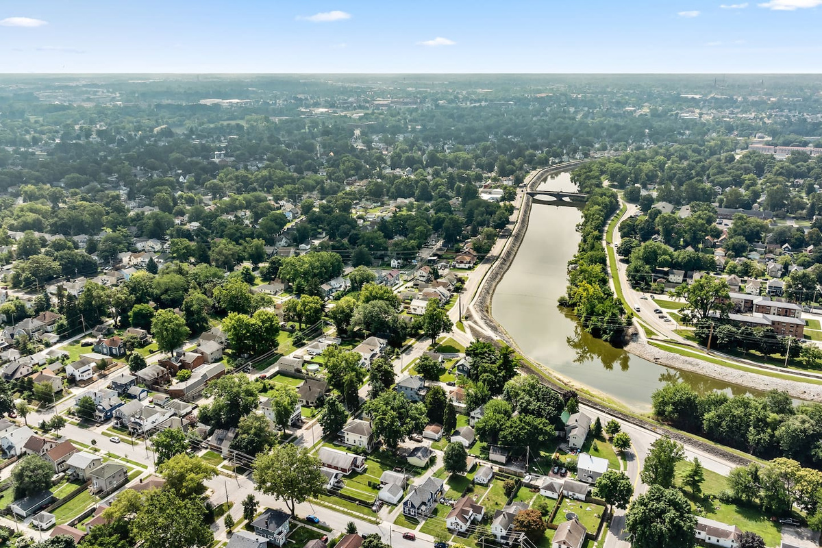 A bird's-eye look at the surrounding neighborhood, with a winding river and easy access to local streets.