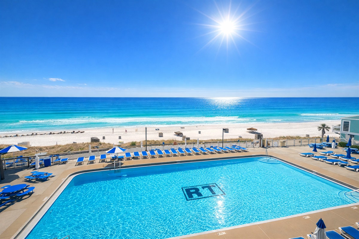 View of pool and ocean from balcony