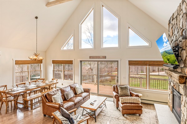 Open-concept main floor with plenty of space, mountain views, and a warm fireplace.
