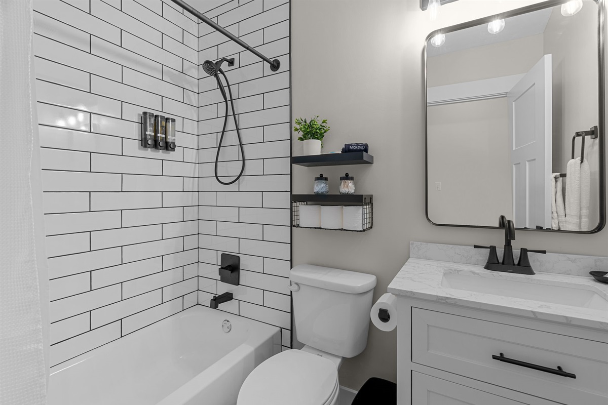 Second floor shared bathroom with shower over tub. Shampoo, conditioner, body wash, hand soaps and hair dryer available for your use.