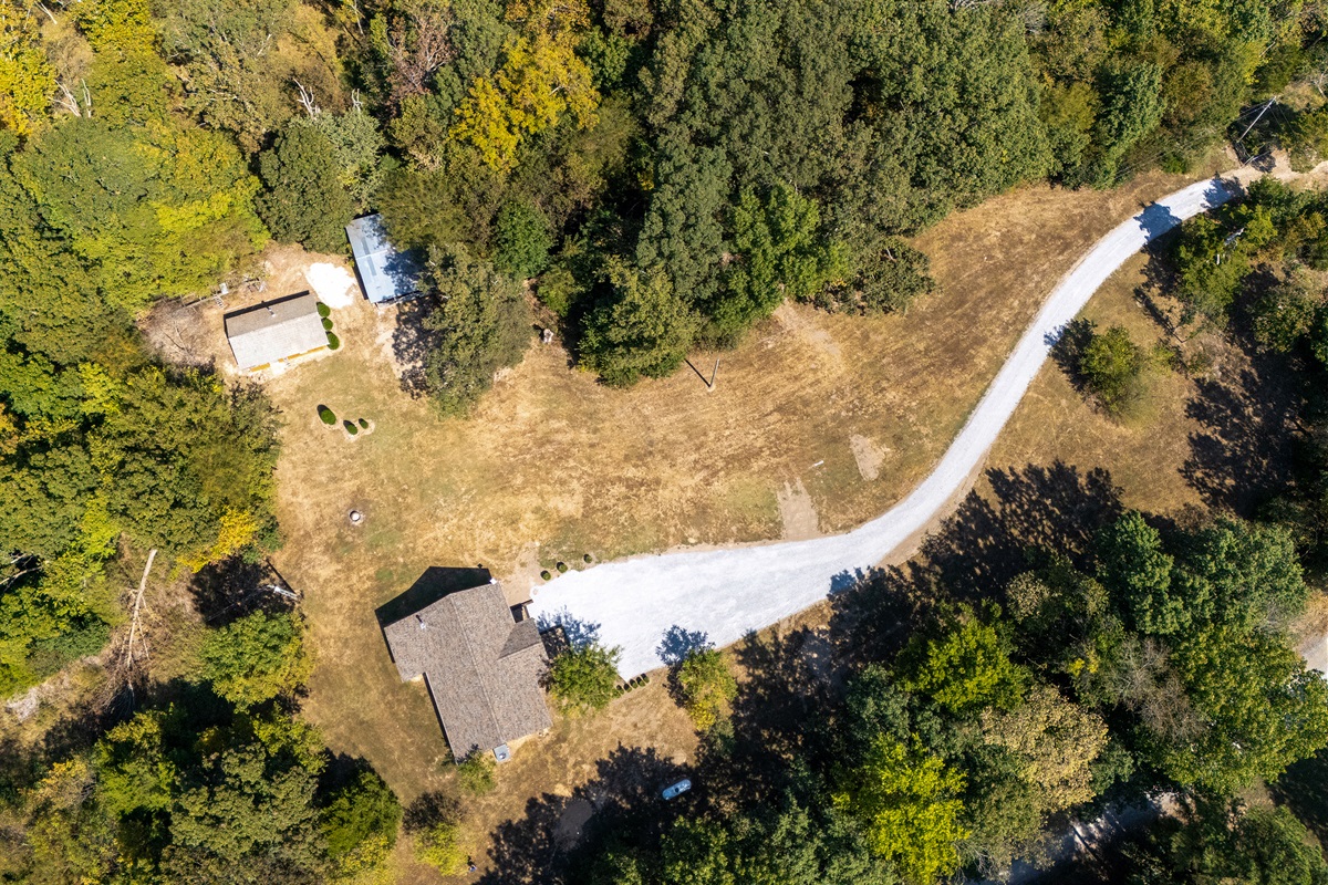 Expansive property with a mix of wooded areas and open green space.