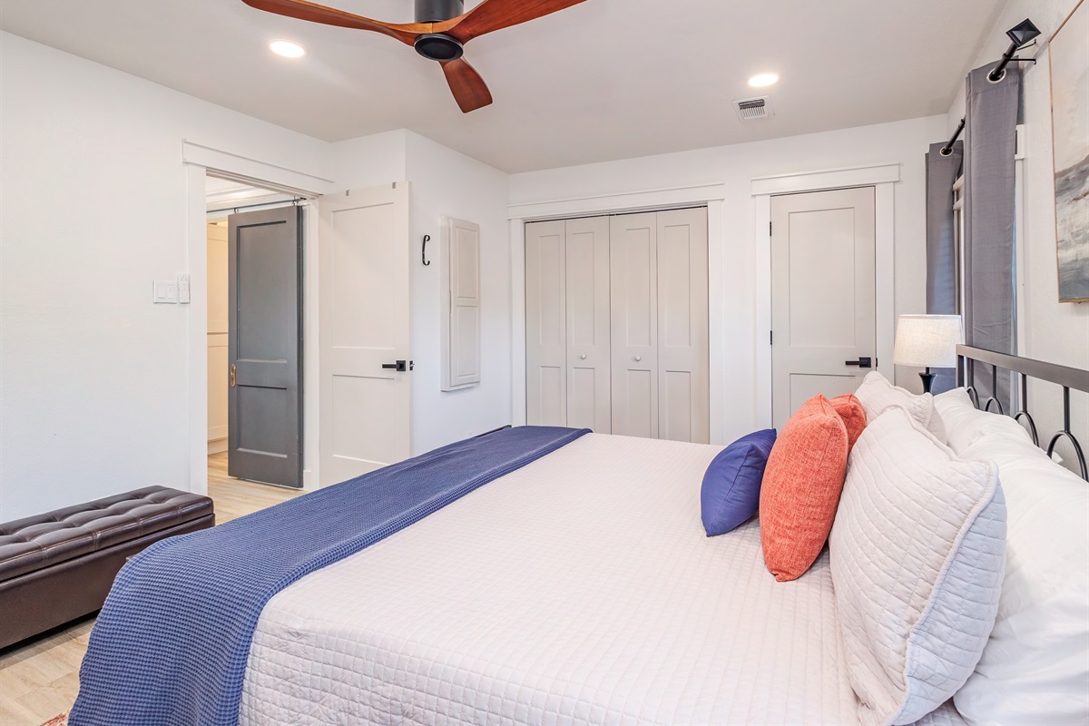 Spacious master bedroom featuring closet, drawers, and bedside lamps with USB charging&mdash;comfort and convenience in one.