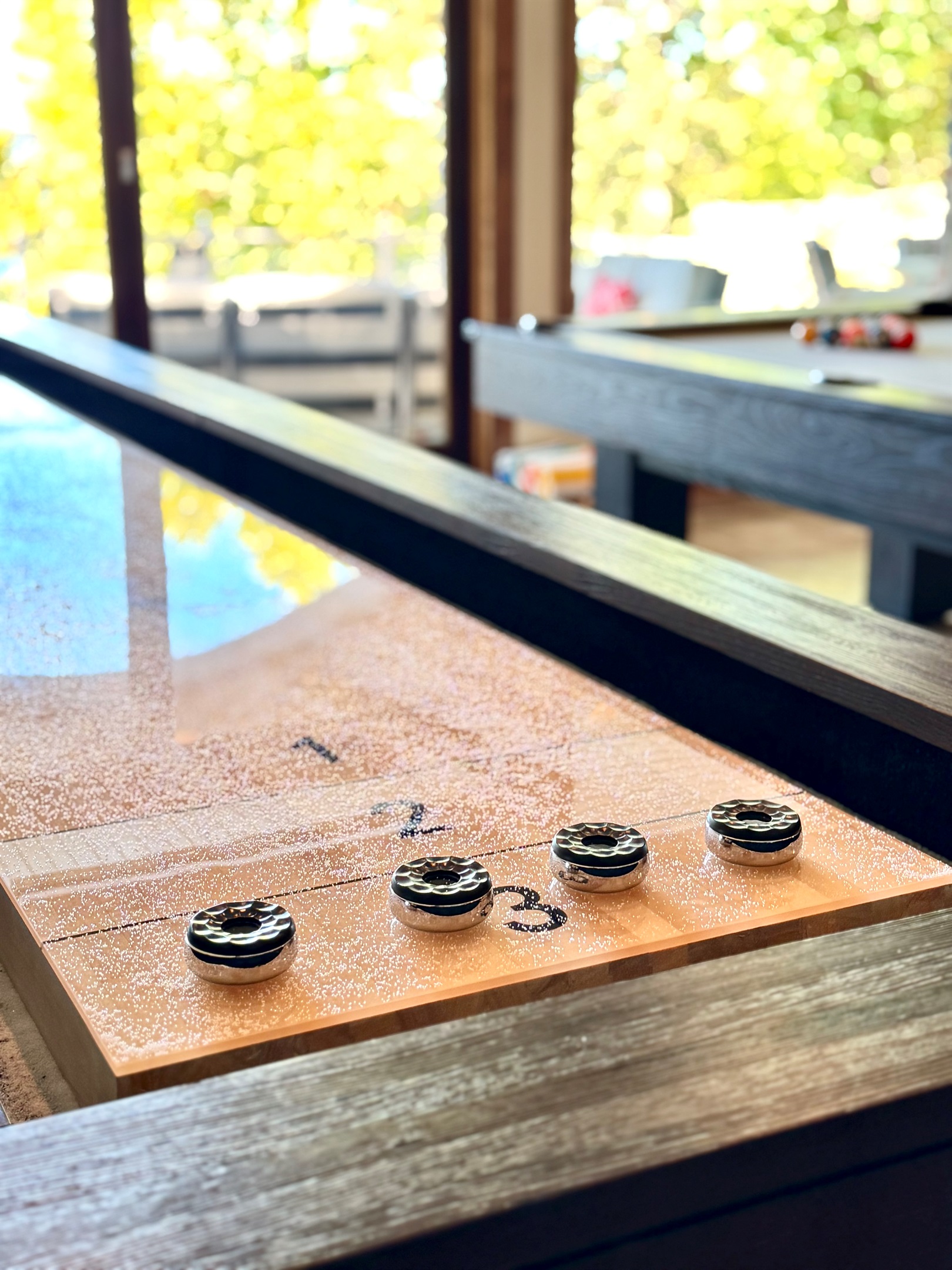 Shuffleboard has bowling pins as well as weighted pucks. 
