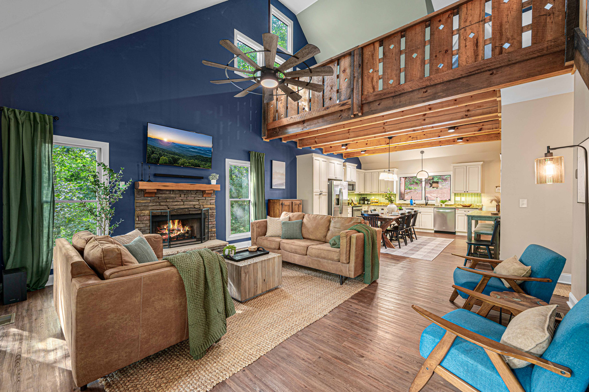 Gather together in the spacious living room with soaring ceilings, a gas-log fireplace, and Smart TV.