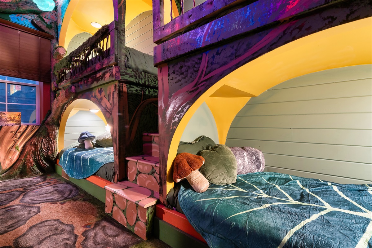 Magical foresty dreamscape bunkroom two queens and four XL twin beds.