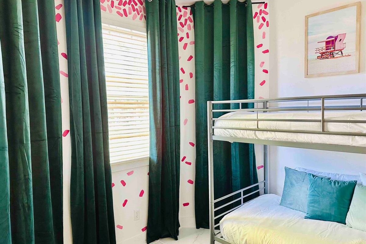 The mainfloor bunk room has floor to ceiling curtains.