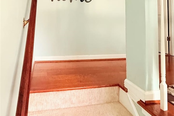 Warm wood stairs and soft walls connect upper and lower levels with ease and style. 