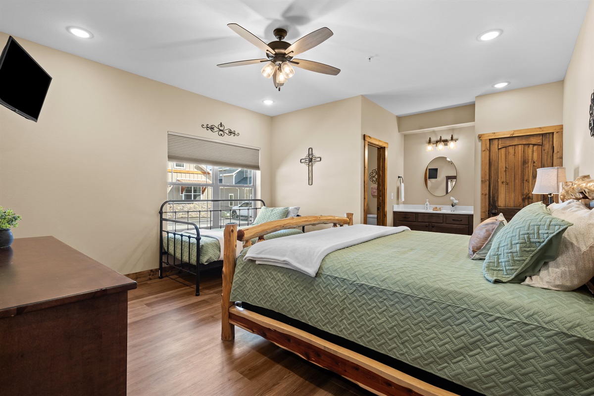 Main level king bedroom with twin bed w/en suite shower/tub
