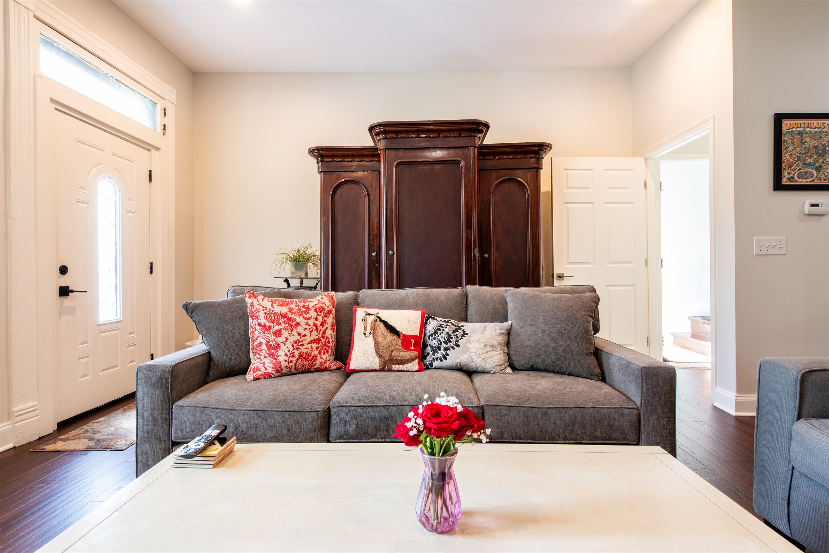 Queen sized sleeper sofa, antique armoire with linens and extra blankets & pillows