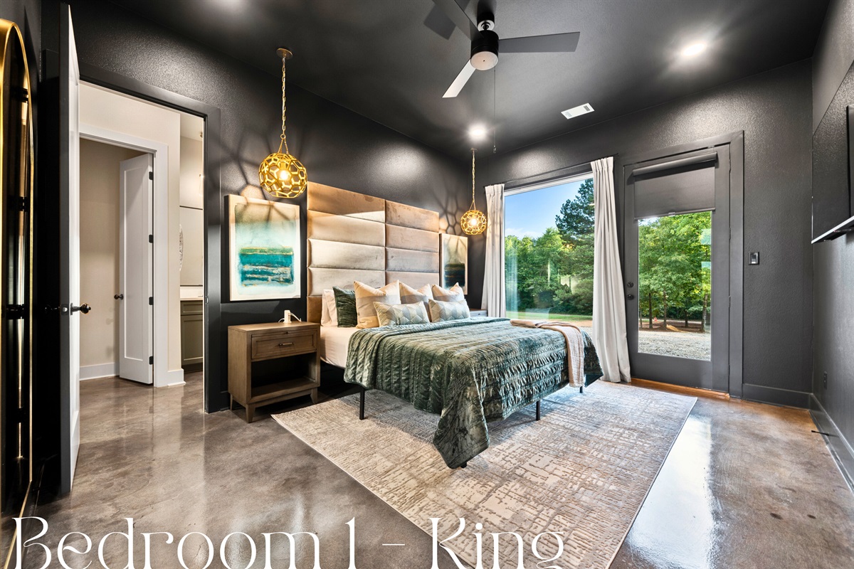 The spacious king-sized bed, featuring an elegant, padded headboard, is the centerpiece of this luxurious bedroom.