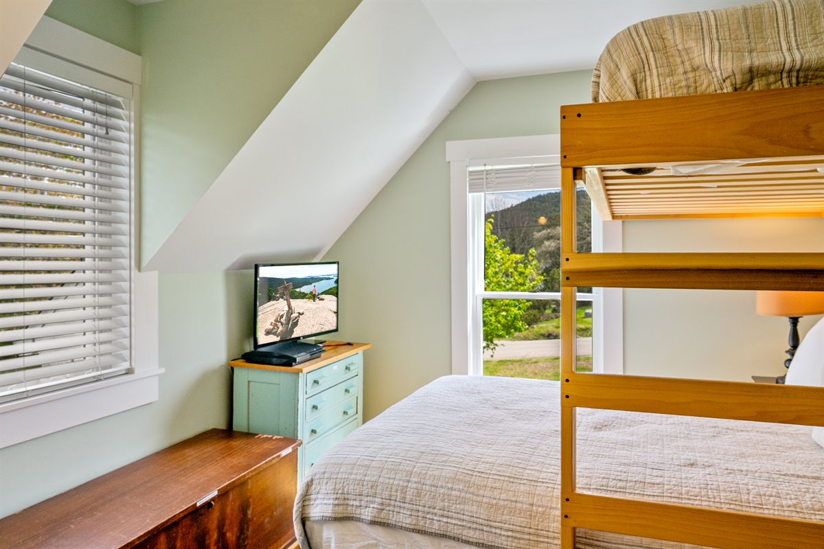 The literal Acadia View. See Acadia Mountain framed in your window from this historic 1880 bedroom. Featuring a twin-over-full bunk, a private Roku TV, and antique charm, it’s a true mountain-view basecamp on the MDI Quiet Side.