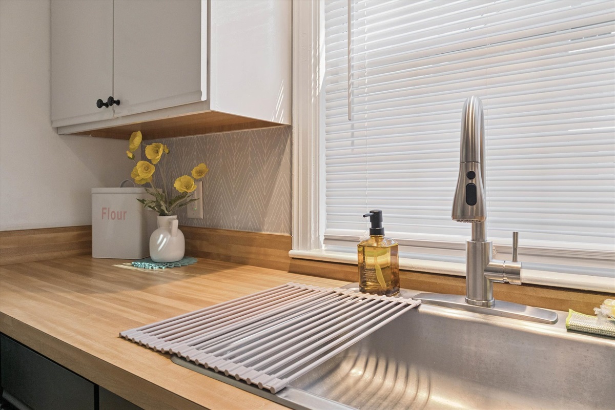 Clean, stocked, and ready to prep—our South Bend kitchen sink features a fresh wrapped sponge, a flour bin for backyard pizza nights, and ample counter space for family-style cooking.
