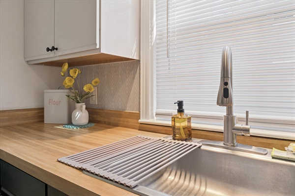 Clean, stocked, and ready to prep—our South Bend kitchen sink features a fresh wrapped sponge, a flour bin for backyard pizza nights, and ample counter space for family-style cooking.