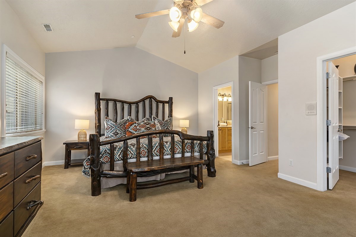 A luxurious primary bedroom with a king bed, warm tones, and a serene ambiance designed for ultimate relaxation.