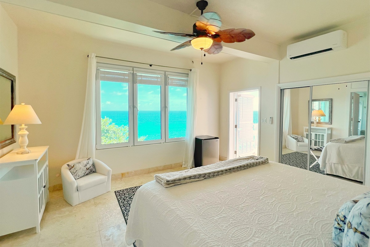 Bedroom combines soft d&eacute;cor with expansive outdoor access.