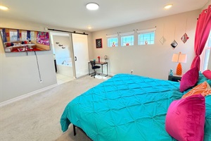 Primary king ensuite with large tub, separate shower, private toilet, and sinks