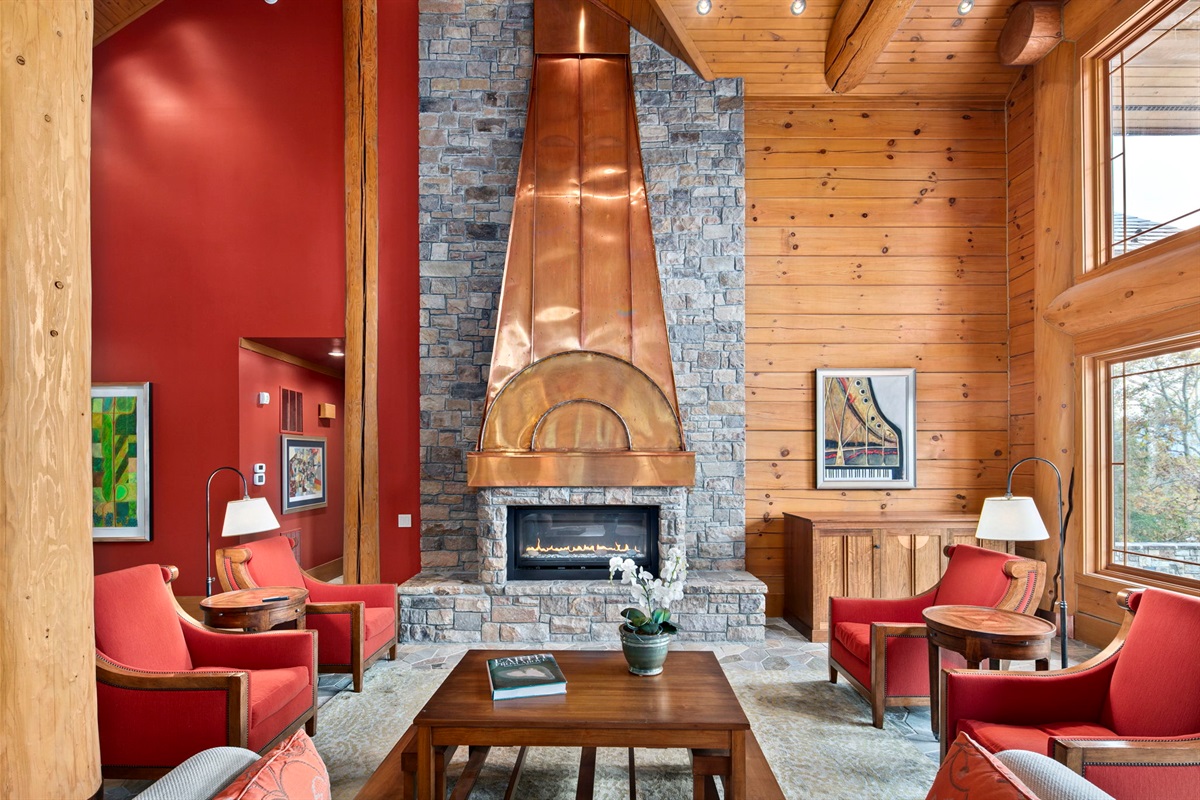 Large airy living room with fireplace, copper chimney and warm light from the back yard