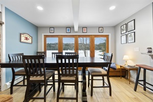 Dining table and view out to the lake through the lower level doors