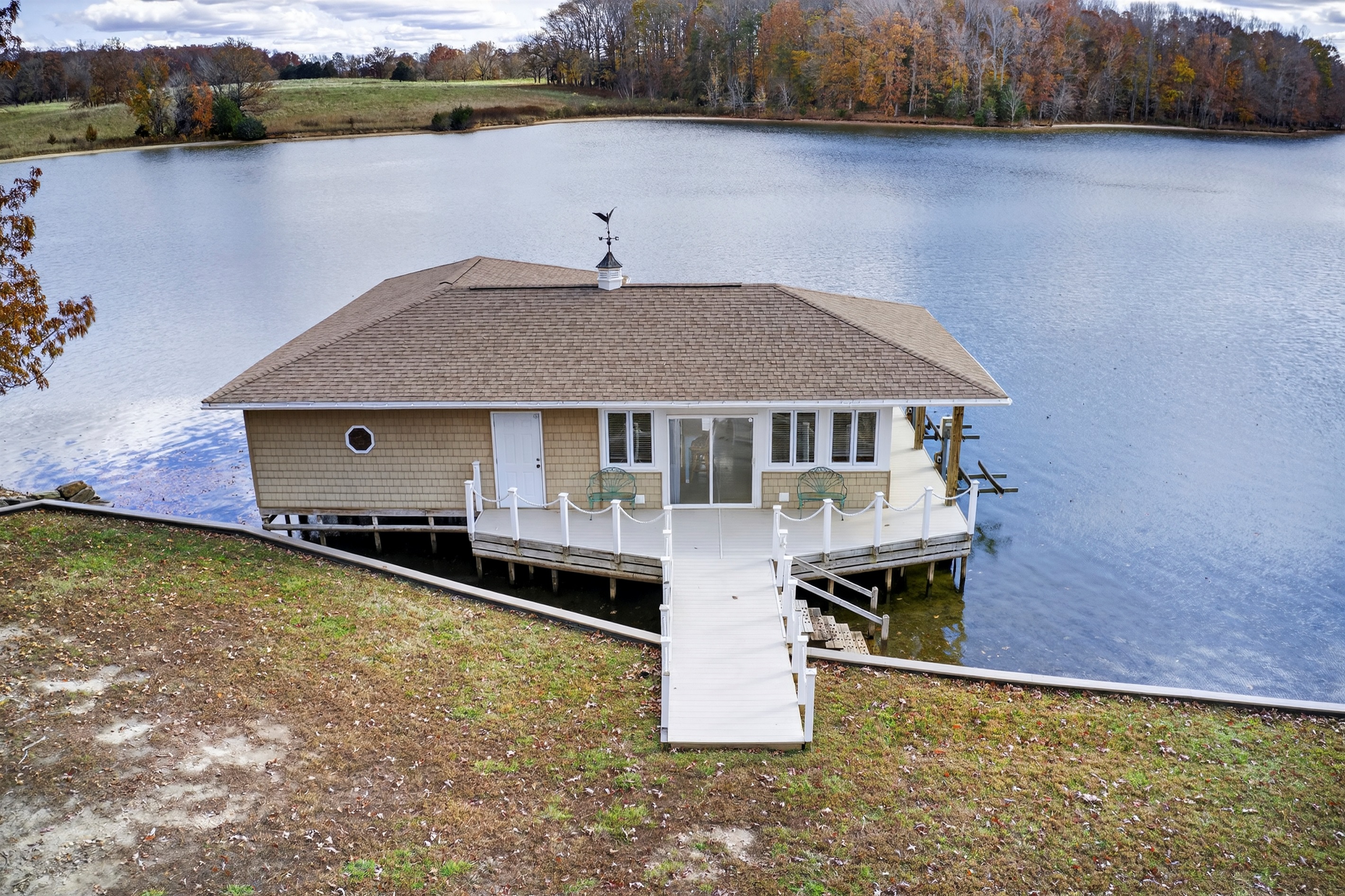 The boathouse features comfy seating, a foosball table, and lake views all around.