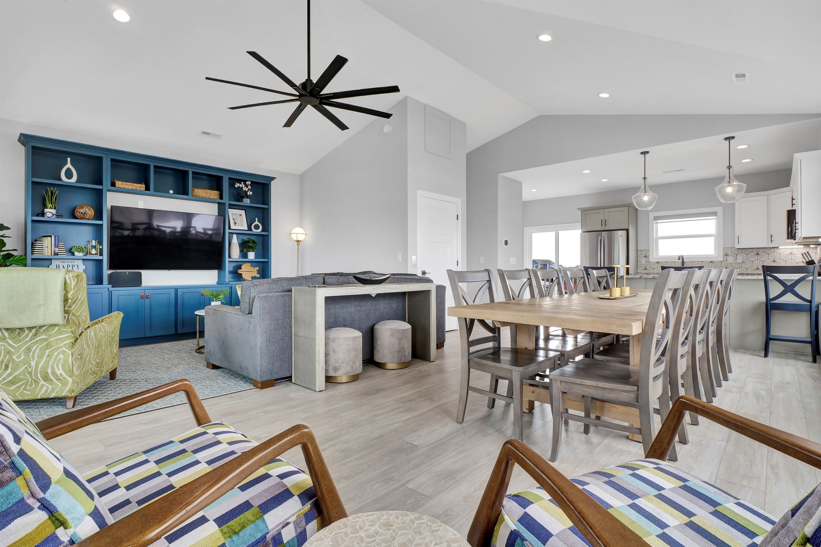 Enjoy the airy, open floor concept on the top floor, where living, dining, and kitchen spaces flow seamlessly—perfect for gathering, entertaining, or simply soaking in the coastal views and good vibes