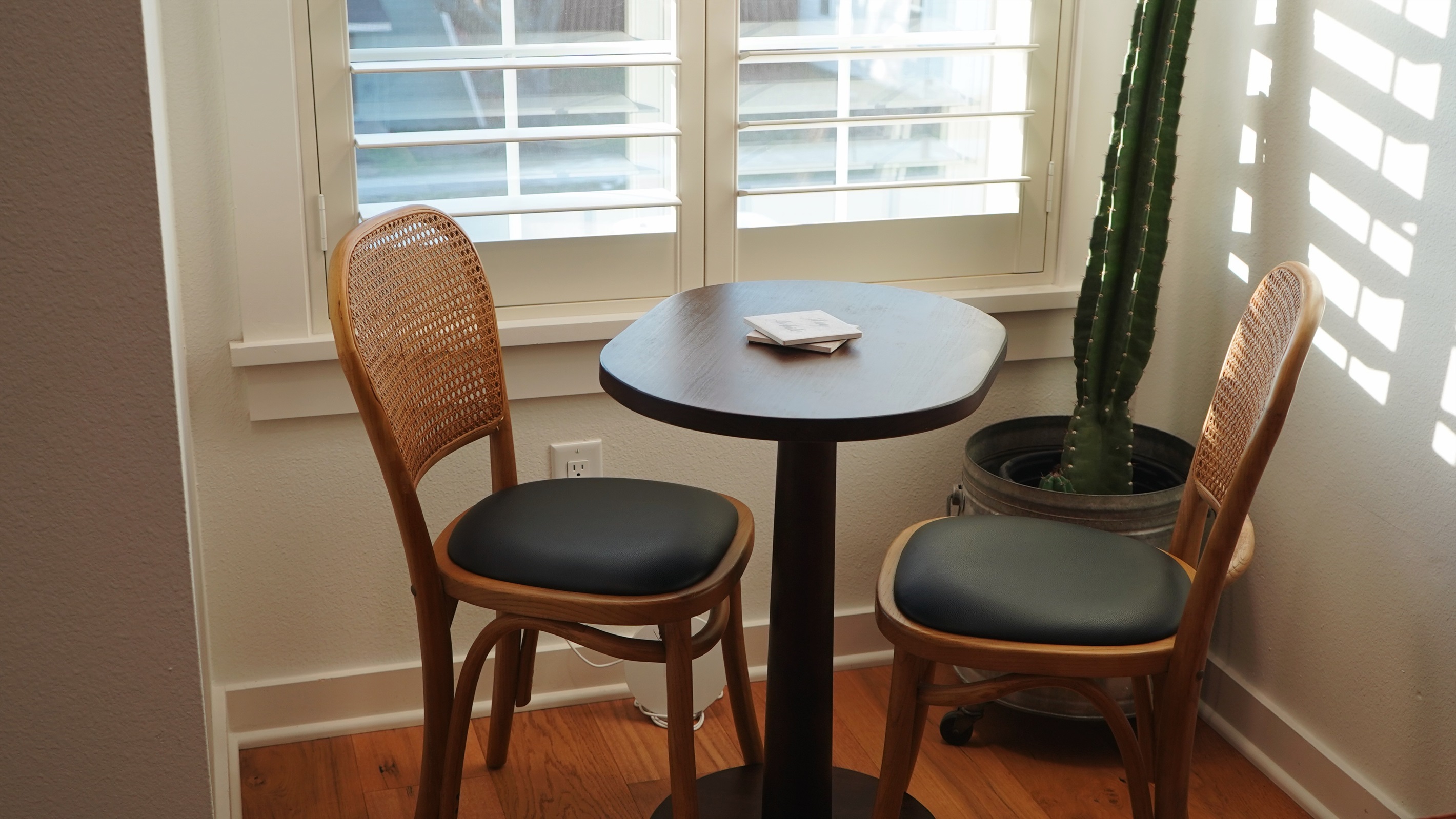 Compact dining table with seating for two, intentionally designed to maximize living space.