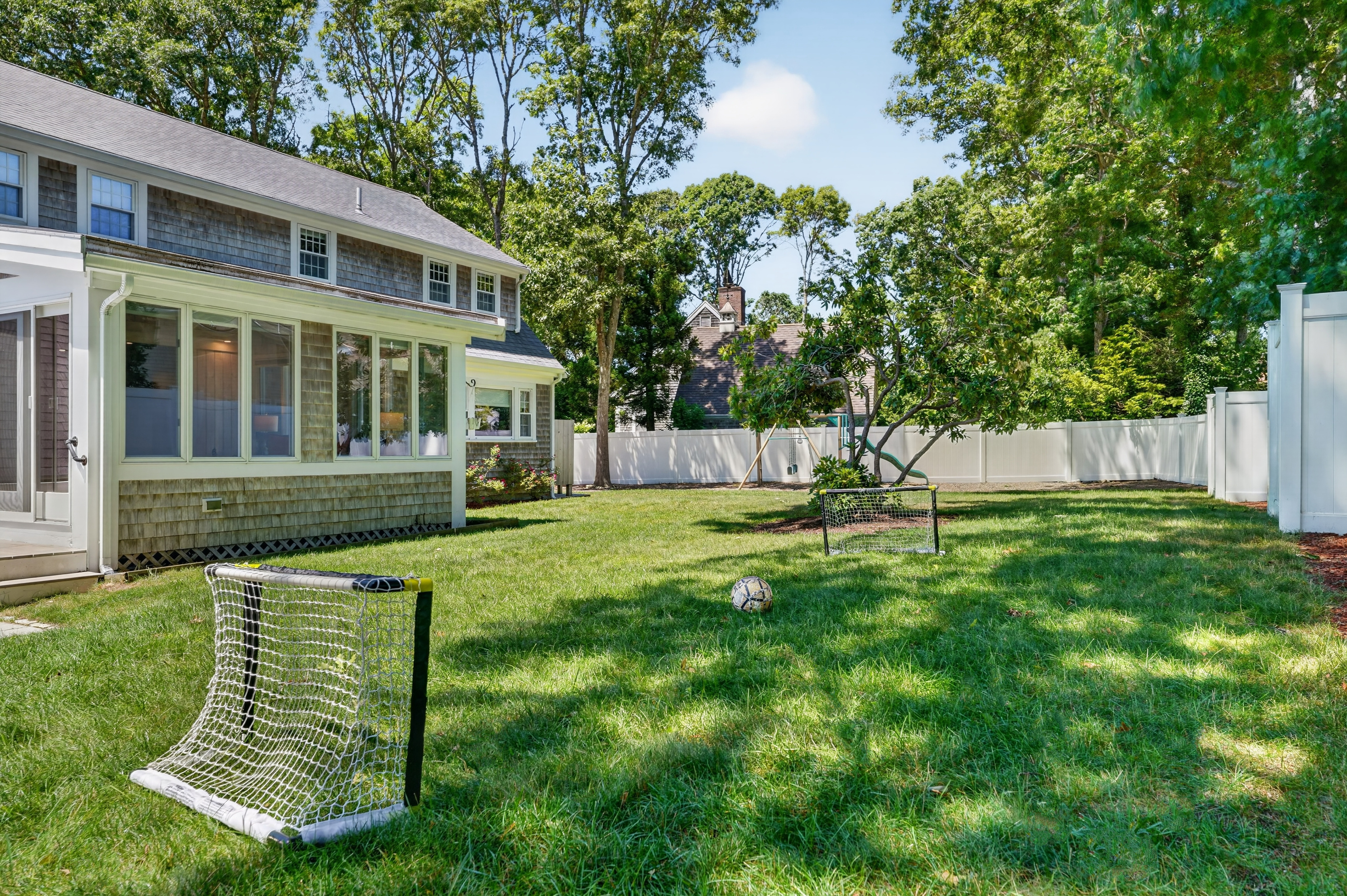 Expansive, fully fenced backyard with plenty of space for outdoor games and family fun.