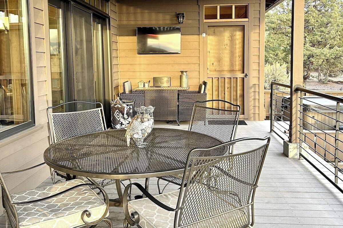 Large back deck with dining area and outdoor TV and grill