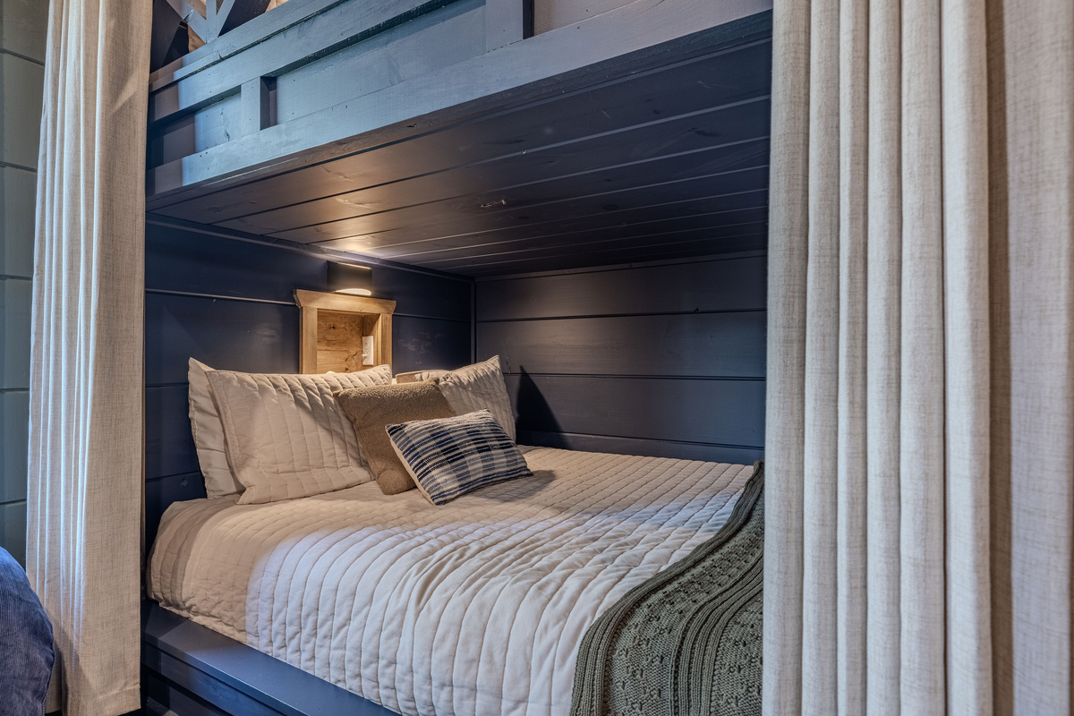 Built-in Queen bunks with individual lights, outlets and phone shelves adds another flexible sleeping option.