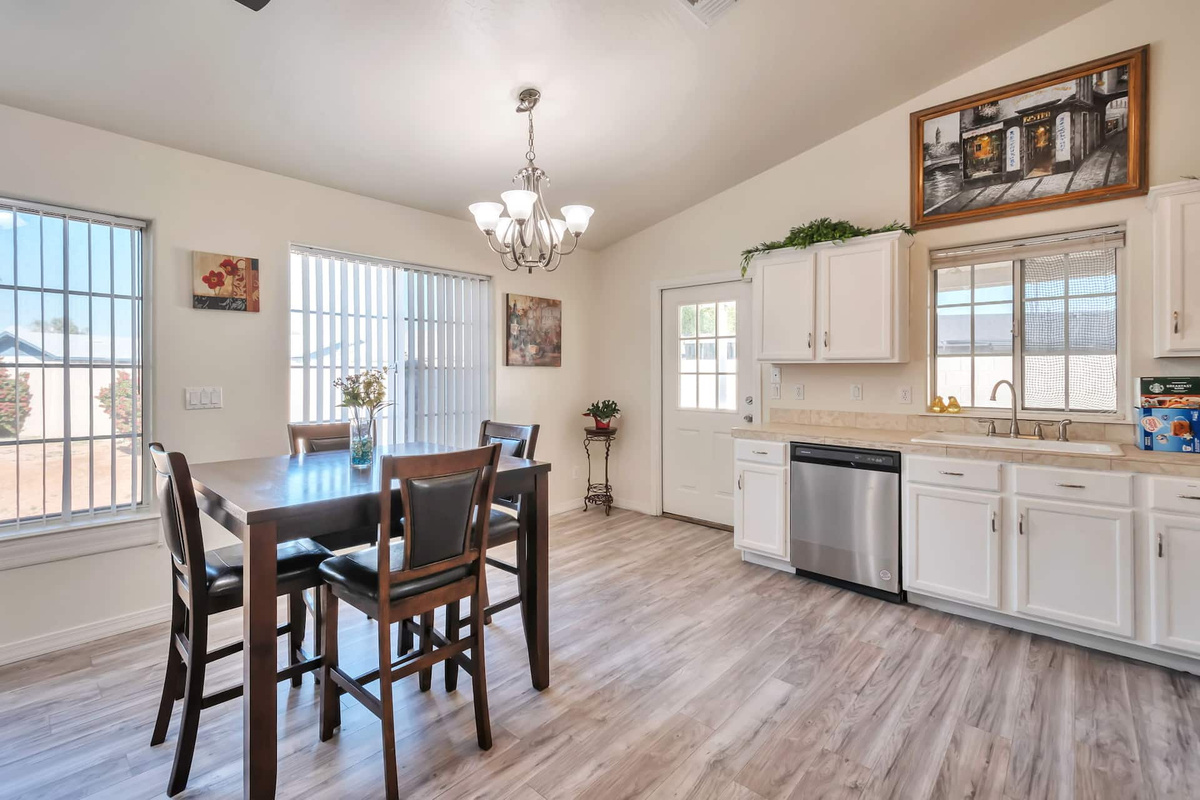 Gather everyone around the table — a sunny dining area for four right beside a full kitchen