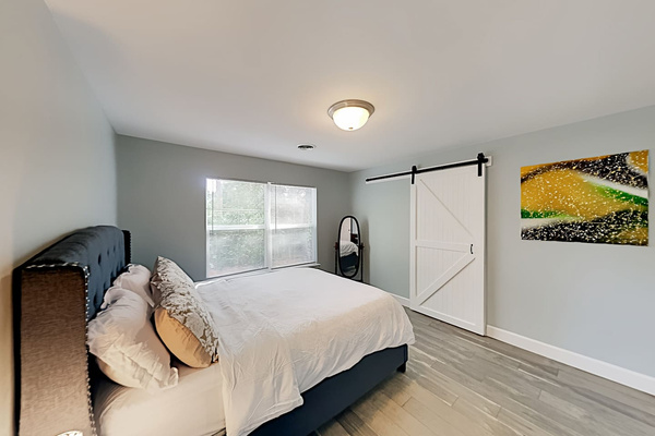 Bedroom Retreat: Bright and airy space with chic decor, inviting you to unwind after beach adventures!