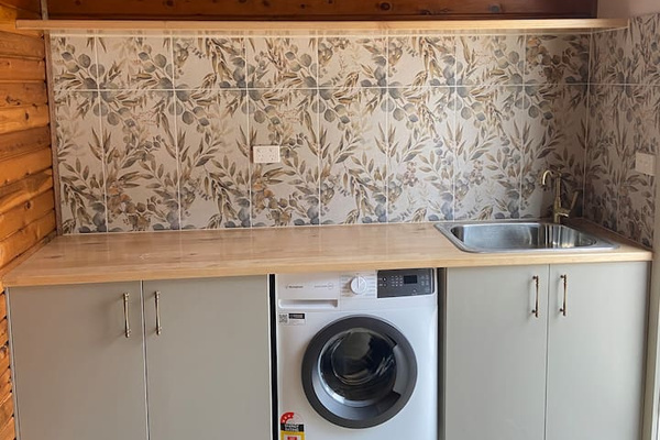 The laundry supports an easy self-contained stay, with space to reset between outdoor time and relaxed evenings at Bob’s River House.