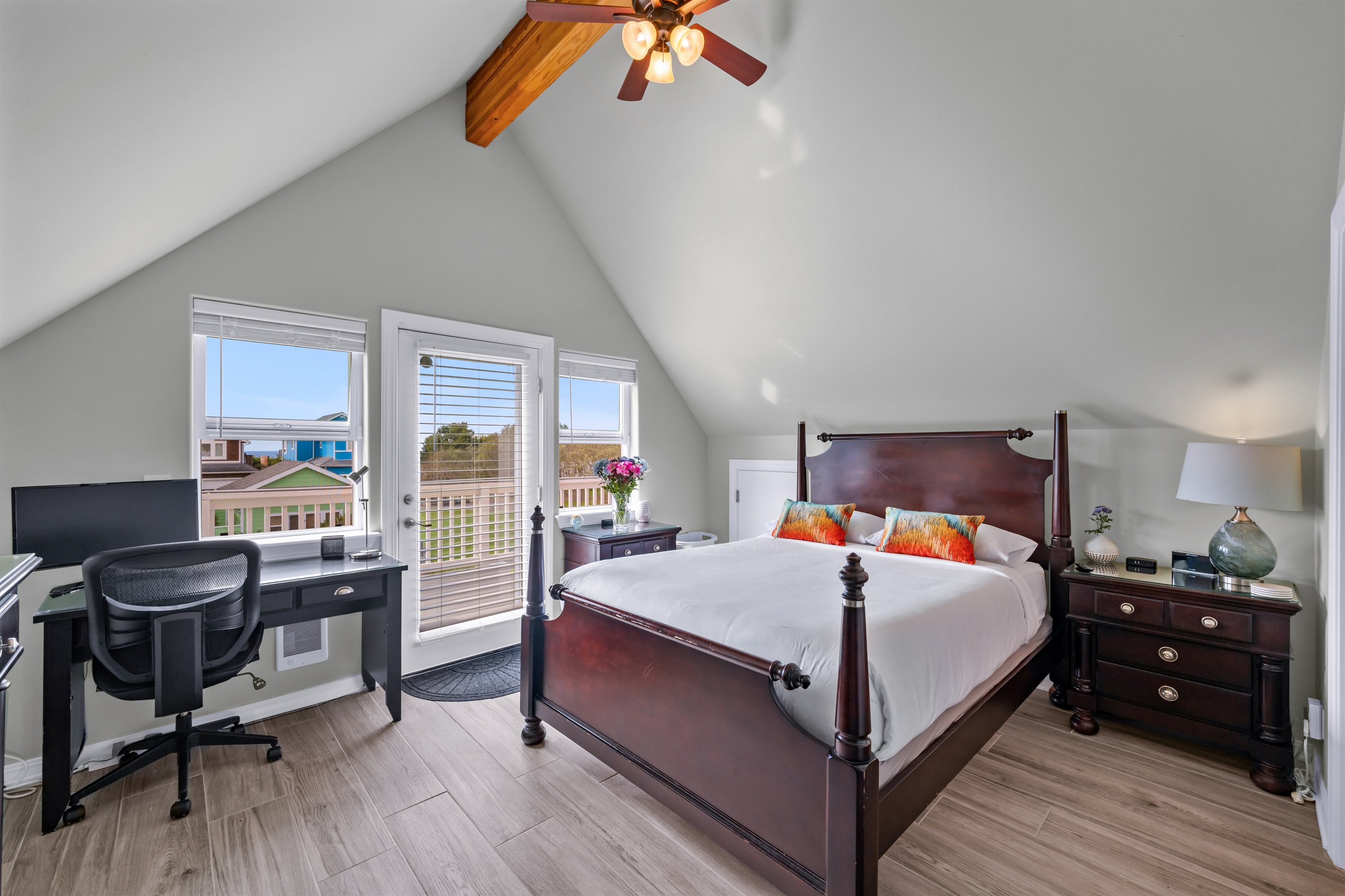 The upper front bedroom accesses the ocean-facing deck and sports a workspace with monitor and ethernet connection.