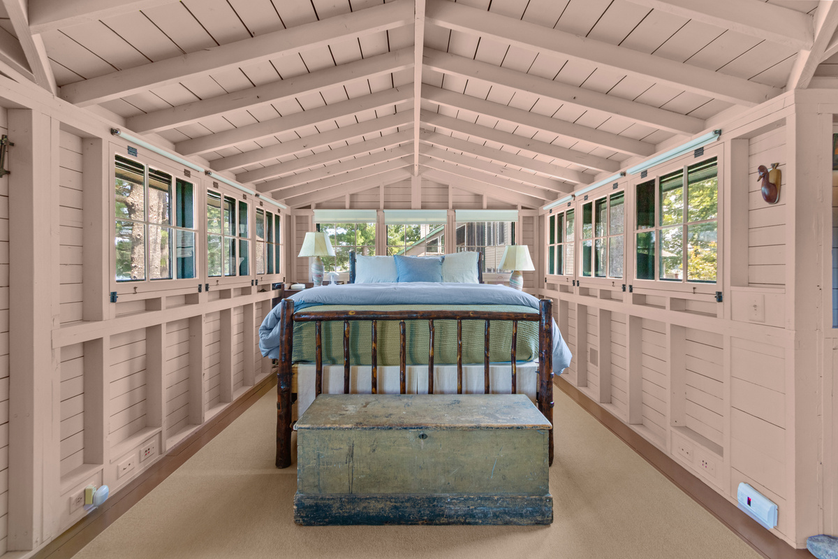 Wake up surrounded by windows and cottage charm in this cozy queen bed, tucked into the spacious upper-level sleeping area.