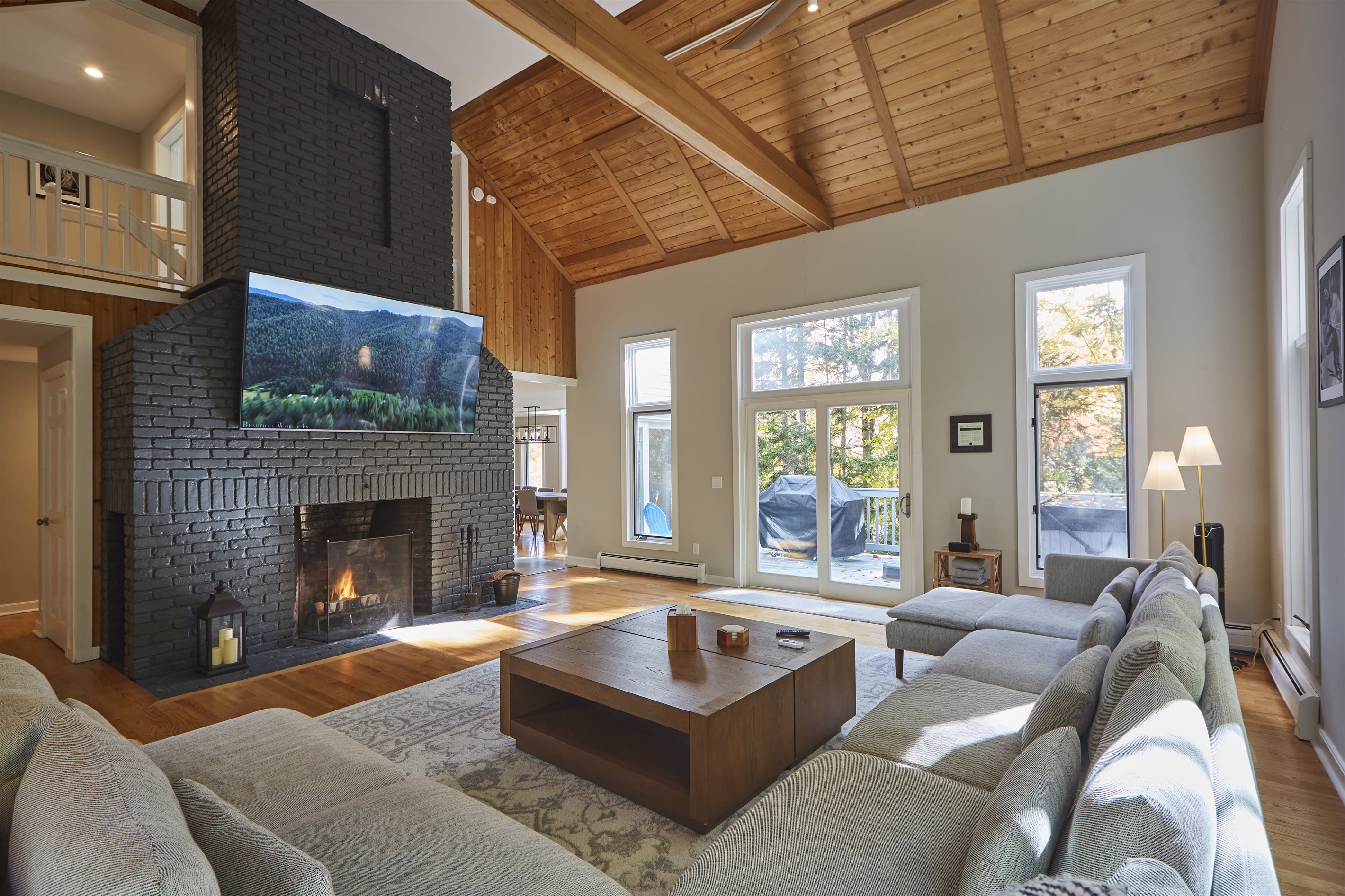 The 86" flatscreen above the fireplace sets the stage for the perfect movie night, creating a cozy, cinematic experience.